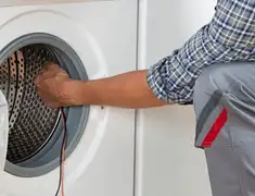 Dryer repair technician diagnosing and servicing a clothes dryer in Chandler, AZ