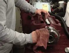 Vacuum repair technician cleaning and servicing a vacuum motor in Chandler, AZ