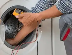 Washing machine repair technician testing a front-load washer with diagnostic tools in Chandler, AZ
